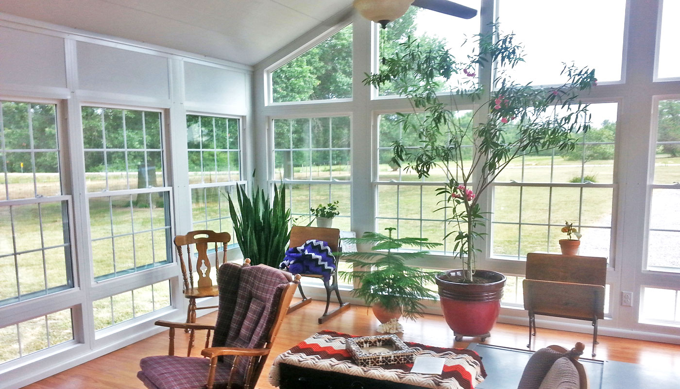 inside of enclosed sunroom with windows