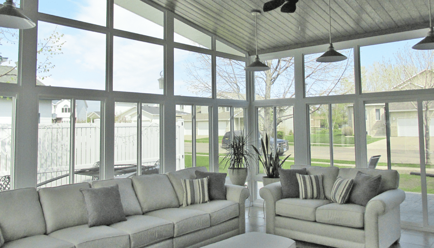 inside of enclosed sunroom with couches